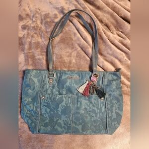 Sakroots Metro Eco-Twill tote bag featuring a nature-inspired with charms